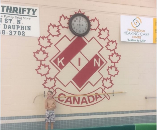 boy with kin canada logo